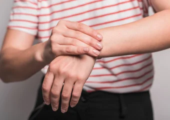 Ilustración de una mano con tendinitis de Quervain mostrando la zona afectada en la muñeca y el pulgar.