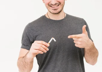 Persona fumando con fondo de radiografía que muestra huesos debilitados por el tabaco.